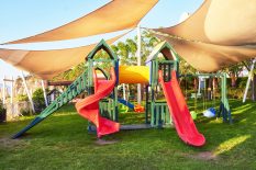 Colorful playground in the yard in the park at sunset