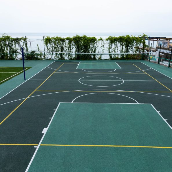 Outdoor Volleyball court with a net in the morning next to the sea.