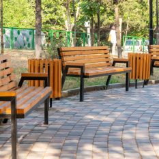 Wooden bench in the city park, place for relaxation. Recreation